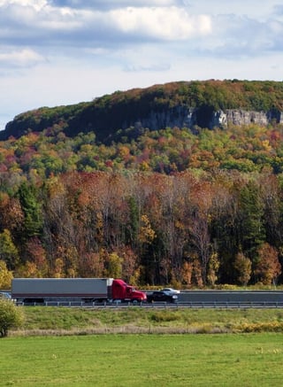 Semi truck on forest highway - trucking specialty coverages